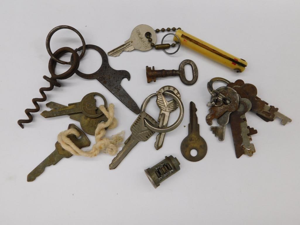 Vintage Keys and Metal Accessories Lot: - Includes a variety of vintage keys, both with and without keychains. | - Features a mix of shapes, including old-style skeleton keys and flat keys. | - Comes with metal accessories like a corkscrew,
