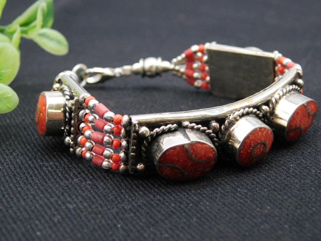 Vintage Coral Bracelet Rock Stone Lapidary Specimen: Vintage bracelet featuring coral beads inset into a silver-tone base. | Designed with intricate beadwork, showcasing orange-red coral in rounded discs. | Secures with a clasp, ensuring ease of wear. |