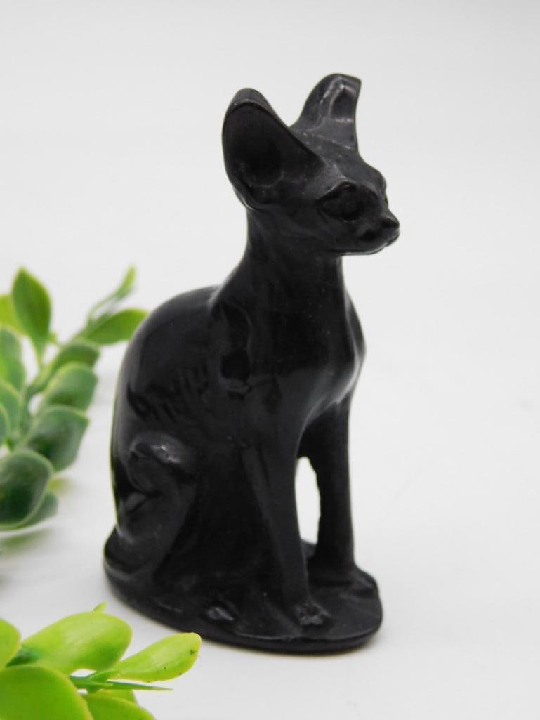 Black Ceramic Sitting Cat Figurine with Glossy Finish Rock Stone Lapidary Specimen: Black ceramic figurine of a sitting cat with a glossy finish | Detailed design with upright ears and smooth contours | Approximate weight: 93 grams (as shown in the image) | Small size suitable for di