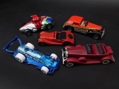 Collection of 5 Diecast Toy Cars by Various Makers: This lot includes five diecast toy cars from various brands, including Hot Wheels and Matchbox. Each vehicle features distinct designs and colors. Makers' marks and dates are visible on the undersides