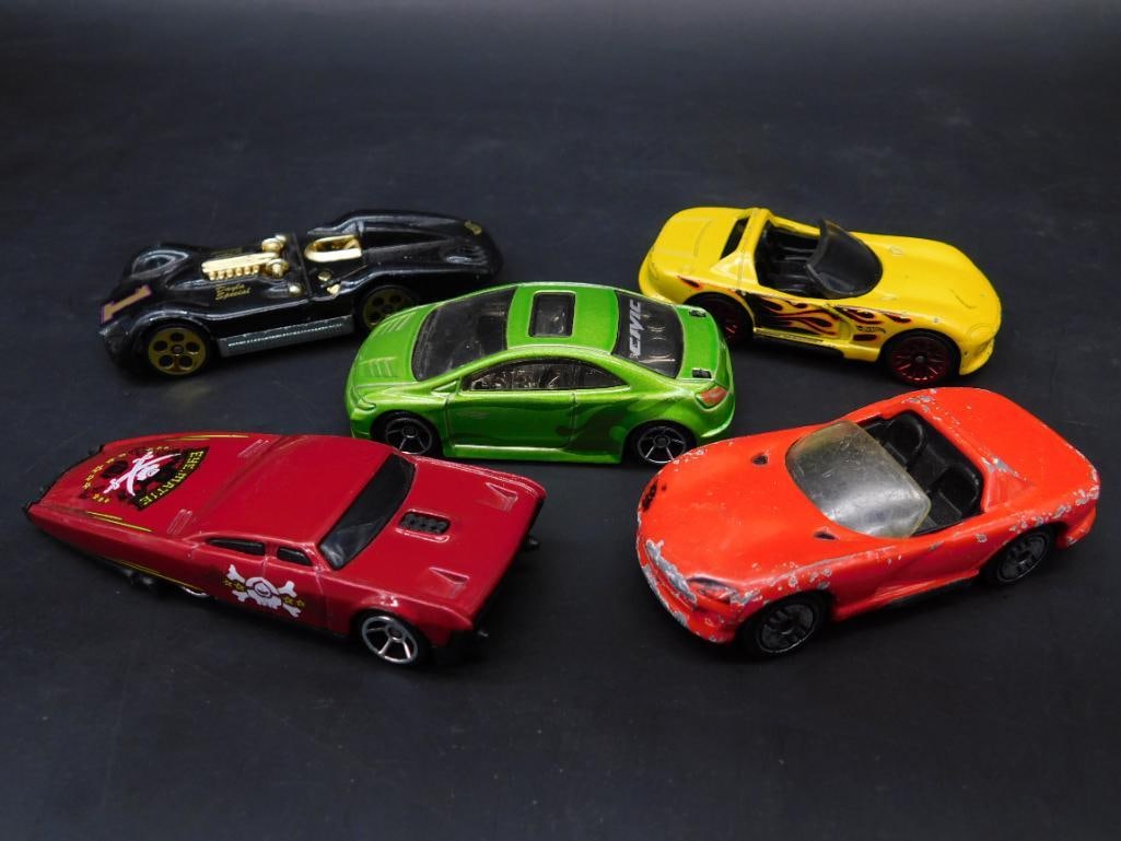 Collection of 5 Diecast Toy Cars: This listing features a set of 5 diecast toy cars by Hot Wheels and Matchbox. The cars include various models with differing designs, colors, and detailing. Visible wear and paint chipping on some car