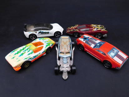 Set of 5 Mattel Hot Wheels Die-Cast Cars: This lot includes a set of five Mattel Hot Wheels die-cast cars. Manufactured in various years (1977, 1982, 1993, 2005), these models were made in Malaysia. The set features a Pontiac Rageous and othe