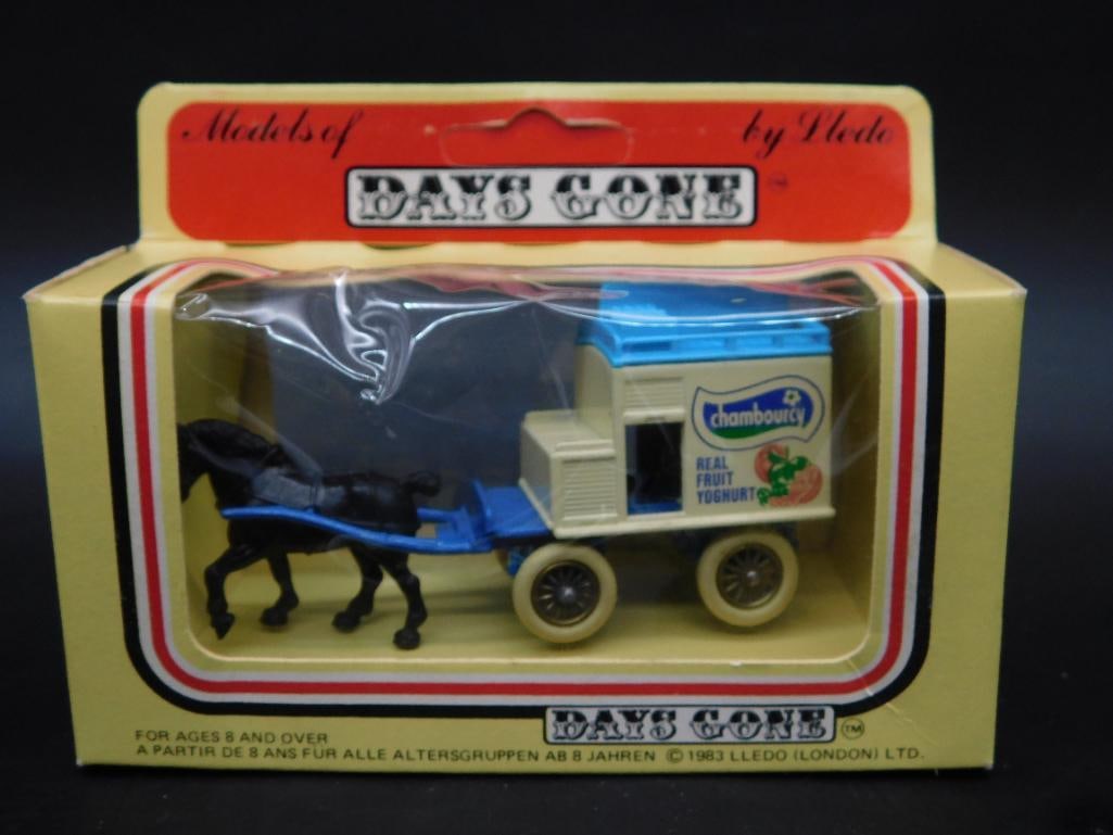 Days Gone Horse-Drawn Chambourcy Yogurt Cart Model: This is a Days Gone toy model featuring a horse-drawn Chambourcy Yogurt cart. The cart is part of the Matchbox 'Models of Days Gone' collection. It is housed in its original packaging, which is in vis