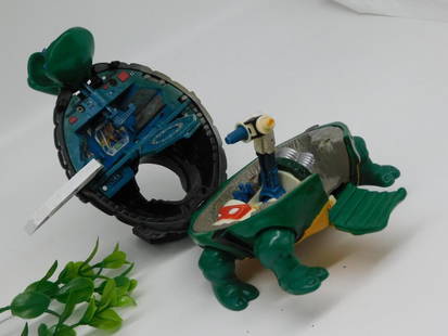 1994 Mirage Studios TMNT Turtle Toy: - Vintage action figure toy from 1994, produced by Mirage Studios/Playmates Toys. | - Green turtle-shaped vehicle or playset with articulated parts. | - Interior features miniature details, including