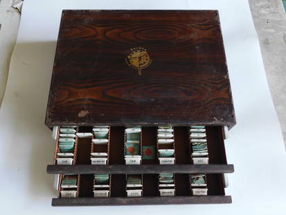 Vintage Bulova Watch Parts Storage Box With Contents WATCHMAKING WATCHMAKER TOOLS: - Wooden storage box featuring the classic Bulova logo and text that reads "Genuine Standardized Parts." | - Includes a collection of labeled compartments containing various small watch parts, such as