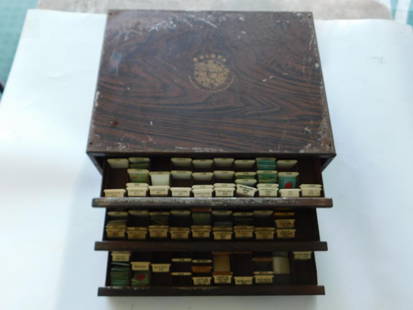 Bulova Repair Master #100 Watch Parts Cabinet WATCHMAKING WATCHMAKER TOOLS: - Vintage Bulova Repair Master #100 wood cabinet | - Features three drawers labeled with compartments for watch parts | - Contains a wide variety of watch parts, including labeled balance staffs, roll