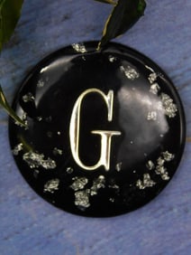 Black Resin Disc with Silver ?G? and Metal Symbol