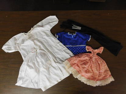 Vintage Doll Dresses and Black Stockings: - Includes four vintage doll dresses in various styles and colors: white dress, blue dress with floral prints, red and white checkered dress, and a baby doll style orange print dress. | - Comes with o