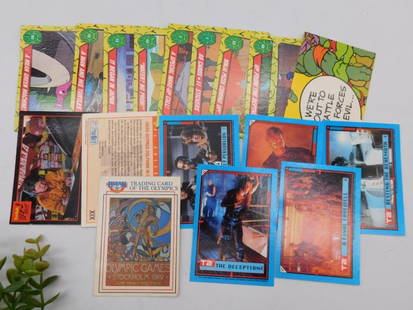 Vintage Trading Cards: Lot includes a variety of vintage trading cards featuring diverse themes and franchises. | Cards appear to be from various sources such as sports, movies, comics, and collectible series. | Includes ca