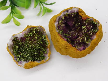 Geode Rock Stone Lapidary Specimen: - A geode pair featuring purple amethyst crystals adorned with chalcopyrite coating for a metallic green-gold effect. | - Natural rock exterior with a vibrant, glittering interior. | - Weighs approxim