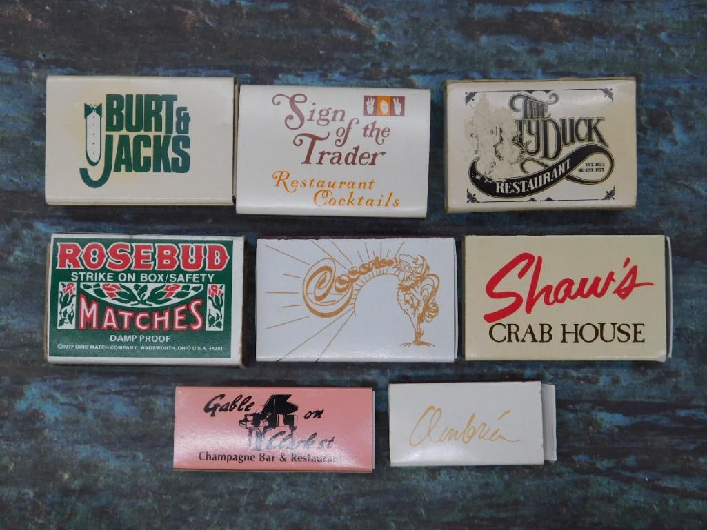 Collection of Vintage Restaurant Matchboxes: Set of seven matchboxes featuring restaurant branding. Includes Burt & Jacks, Sign of the Trader, The Stork Club, Rosebud Matches, Shaw's Crab House, Gale on Clark Champagne Bar & Restaura