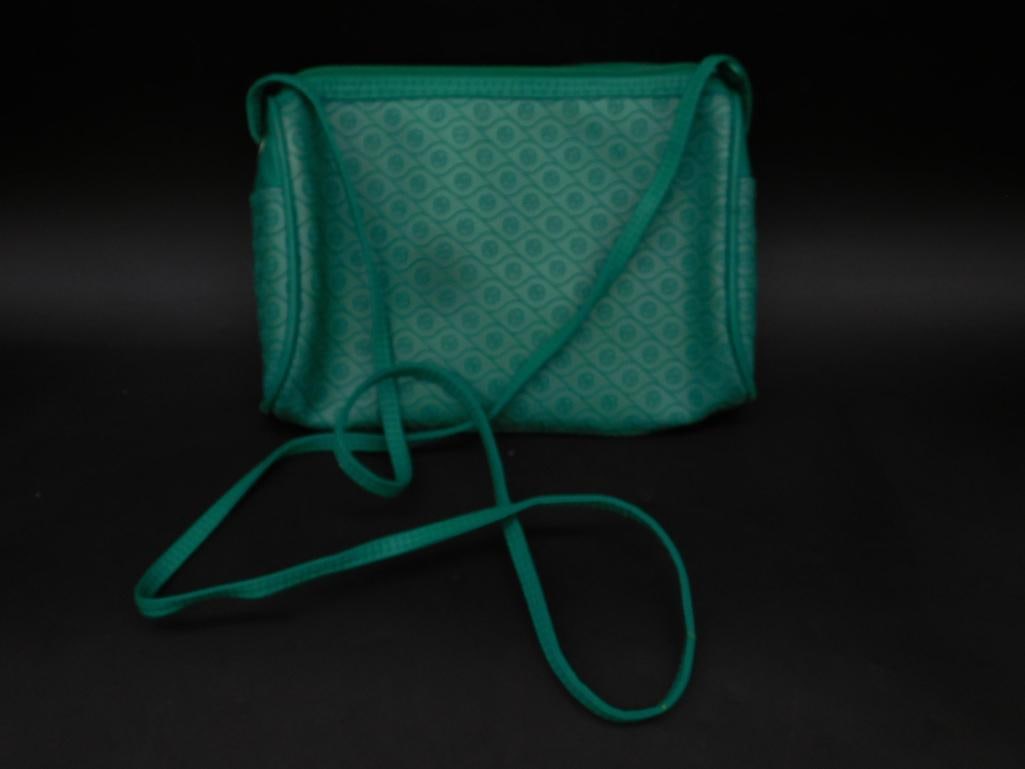 Green Crossbody Bag with Patterned Design: Green crossbody bag featuring a patterned design on the exterior. Includes a zipper closure and a matching adjustable strap. Interior tag indicates 'Made in Taiwan R.O.C.' Measures approximate