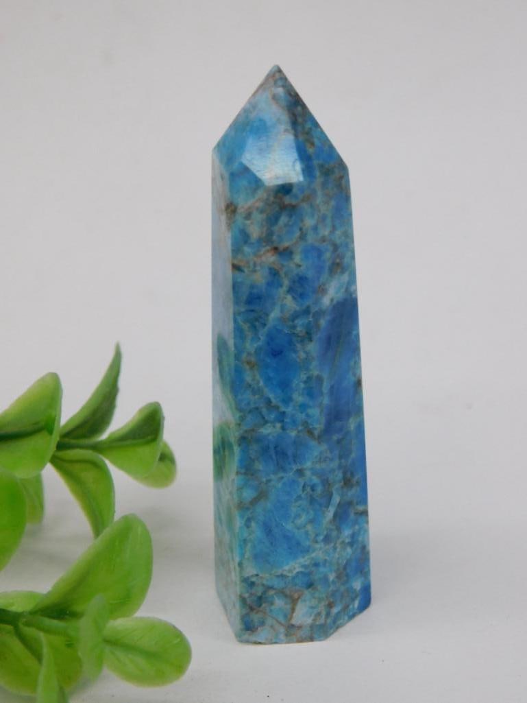Blue Apatite Stone Point Quartz Crystal Tower ROCK STONE LAPIDARY SPECIMEN: A blue polished quartz crystal tower featuring a tapered point design. The dimensions are not specified, but a ruler is included for scale indicating an approximate height. This item is likely intende