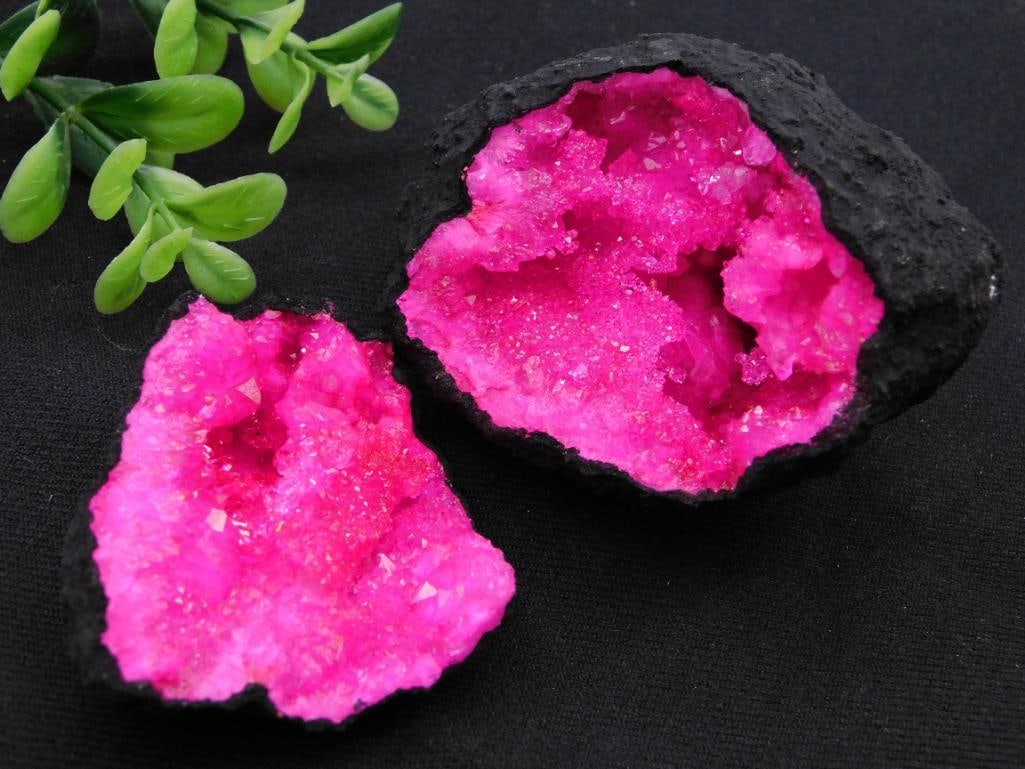 Pink Geode With Black Exterior Rock Stone Lapidary Specimen: Features a vivid pink crystal quartz interior with a natural sparkling geode formation. | Outer shell is black, providing striking contrast to the bright pink inner crystals. | Geode separates into tw
