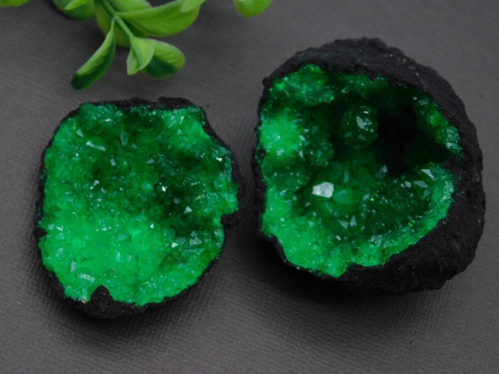 Bright Green Geode Specimen Pair Rock Stone Lapidary Specimen: Vibrant green geode with crystal formations on the interior | Comes in a split pair, showcasing matching halves | Outer surface with natural rock texture and black coating | Crystals display high lust