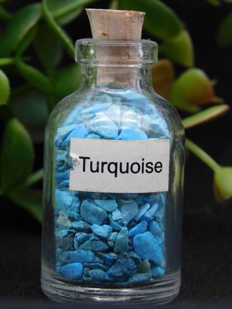 Small Glass Bottle of Turquoise ROCK STONE LAPIDARY SPECIMEN: Glass bottle containing small turquoise chips. | Secured with a cork stopper at the top. | Label on the bottle features the word 'Turquoise.' | Ideal for collectors or decorative purposes. | Approxima