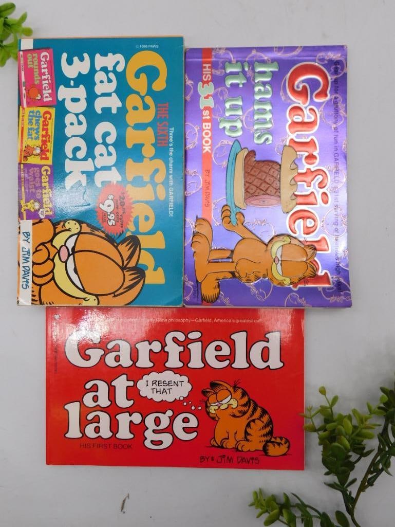 3 Garfield Comic Books in Softcover Format: Includes 3 different titles: "Garfield At Large", "Garfield Hams It Up", and "Garfield Fat Cat 3-Pack" | Softcover editions published by Ballantine Books and Paws, Inc. | First editions: "Garfield At 