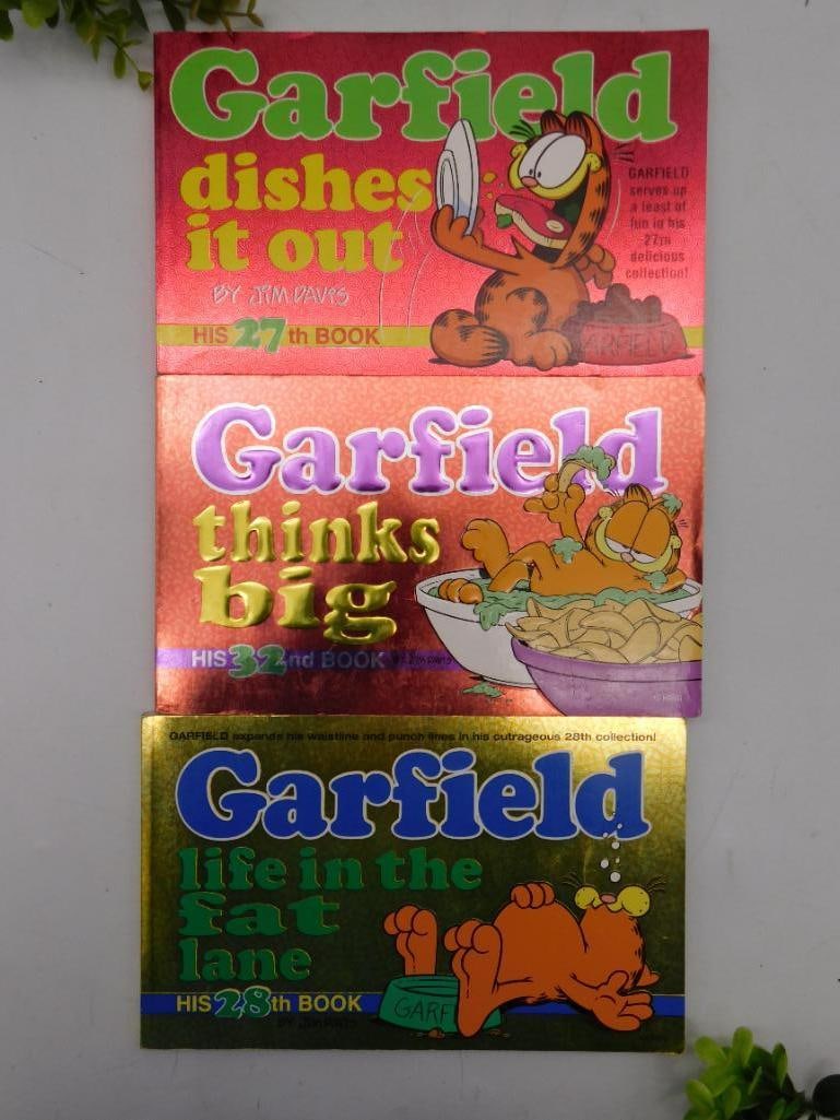 3 Garfield Comic Books With Holographic Covers: Includes three Garfield comic book titles: "Garfield Dishes It Out" (27th book), "Garfield Thinks Big" (28th book), and "Garfield: Life in the Fat Lane" (29th book). | Each book features a shiny, holo