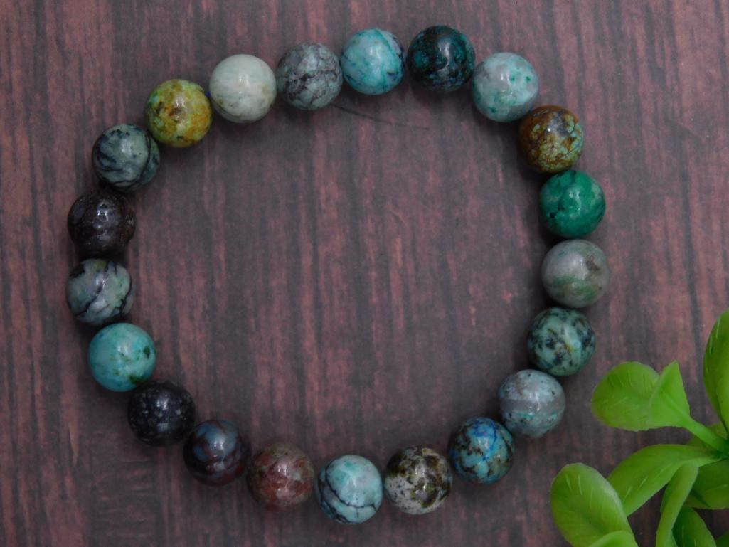 Multicolored Stone Bead Bracelet ROCK STONE LAPIDARY SPECIMEN: Bracelet featuring round, multicolored stone beads. | Includes approximately 20 beads, each with unique color patterns. | Elastic band allows for flexible sizing. | Suitable for various wrist sizes. |