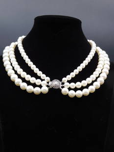 Triple-Strand Pearl Necklace with Decorative Clasp: Elegant triple-strand design featuring white pearls of graduated sizes. | Decorative clasp in silver-tone metal with intricate detailing. | Lengths and pearl size suitable for a classic, layered appea