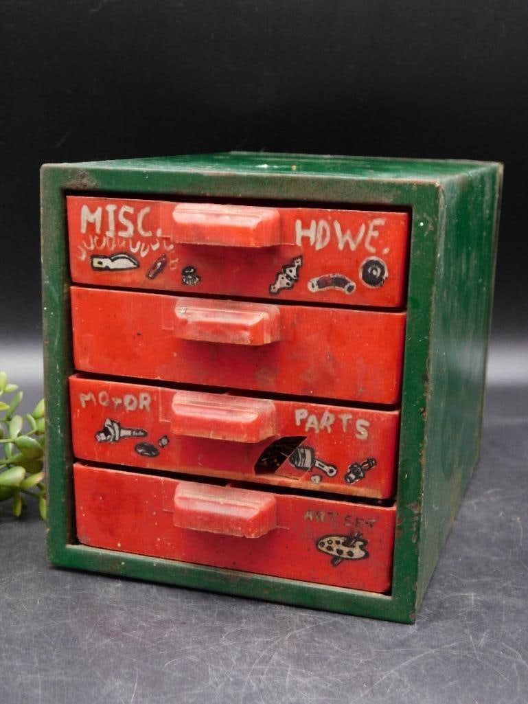 Vintage Metal 4-Drawer Hardware Organizer: Vintage metal organizer with 4 pull-out drawers. | Green exterior with red drawer fronts, hand-painted labels (Misc HDWE, Motor Parts, etc.) and decorative graphics. | Includes an assortment of hardwa