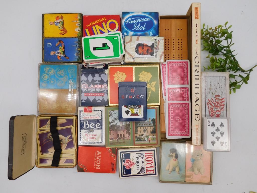 Playing Cards, Uno, Cribbage, and More: Collection of assorted playing cards including branded decks like Gemaco and Bee. | Contains specialty card sets such as 'The Original UNO' and an 'American Idol' themed deck. | Includes a cribbage bo