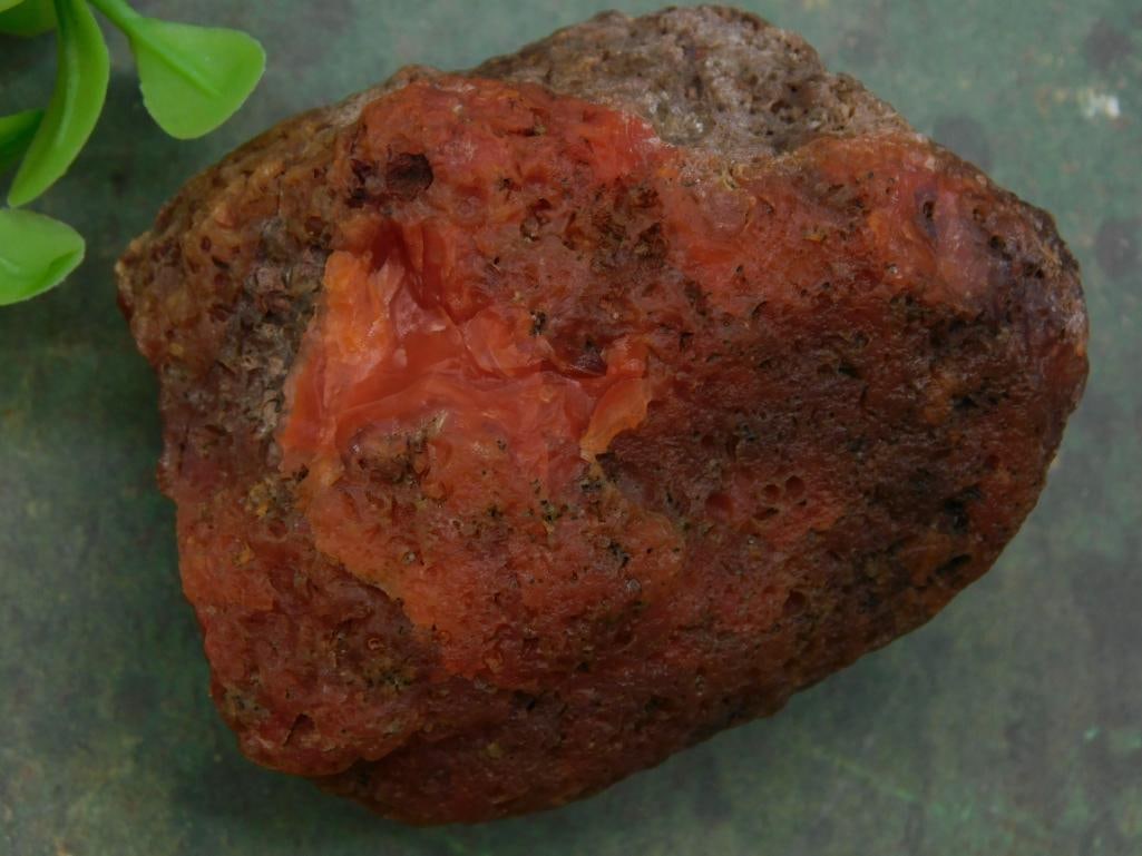 Reddish-Brown Raw Rock Specimen for Collection ROCK STONE LAPIDARY SPECIMEN: Natural reddish-brown rock specimen with rough texture and uneven surface. | Features an irregular shape with pockets and areas of translucency. | Tends toward earthy and rust-like hues with some deep