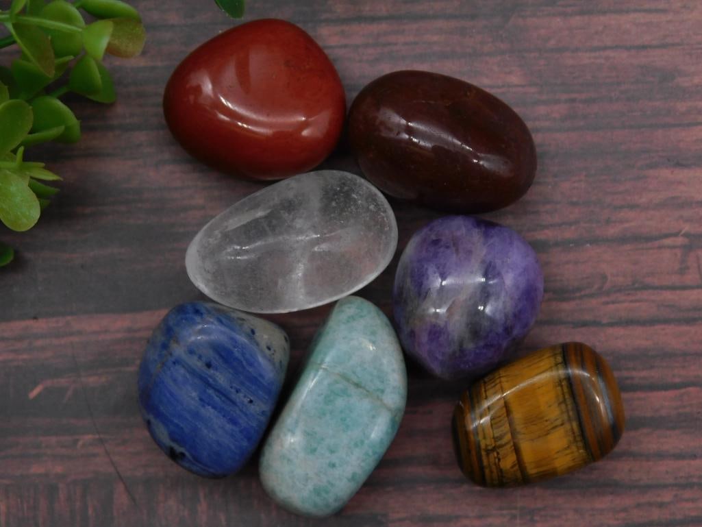 Mixed Tumbled Stones ROCK STONE LAPIDARY SPECIMEN: Includes 6 gemstones in vibrant colors: red, brown, clear, purple, blue, and yellow striped. | Each stone is smoothly polished, showcasing its natural patterns and hues. | Sizes are comparable to a qu