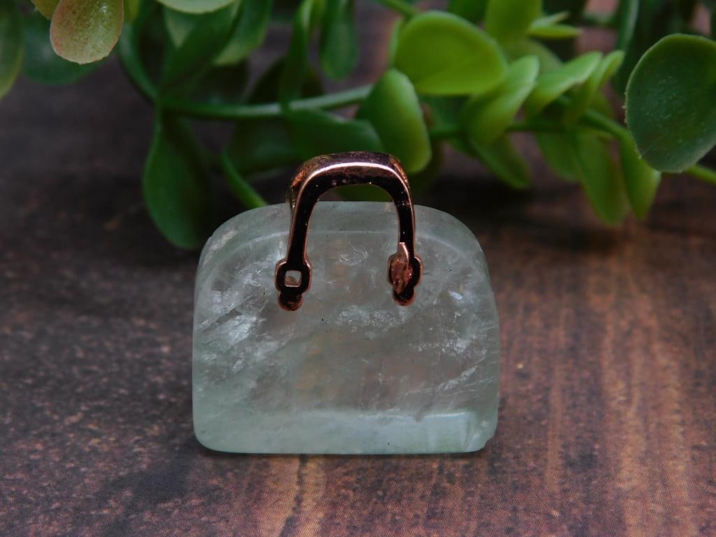 Miniature Green Stone Handbag Sculpture with Metal Handle Rock Stone Lapidary Specimen: Miniature sculpture featuring a green stone base. | Adorned with a metal handle, possibly copper or copper-toned. | Compact design, as shown next to a U.S. quarter for scale. | Lot number 710502 and l