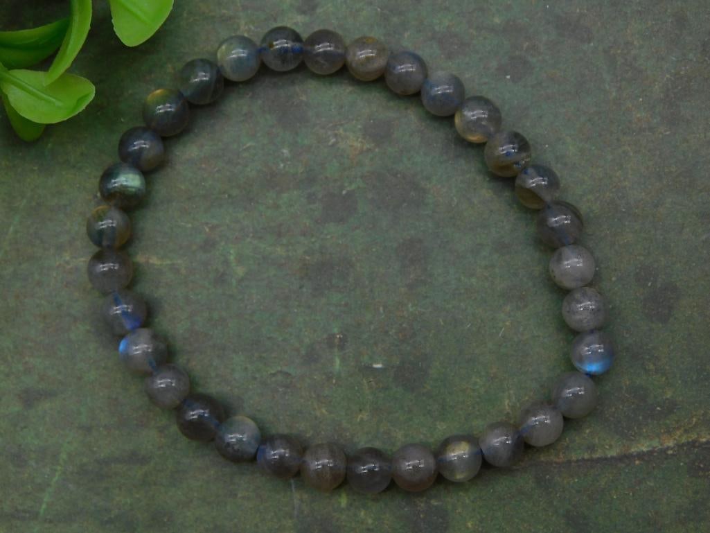 Labradorite Bead Stretch Bracelet Rock Stone Lapidary Specimen: Labradorite bead stretch bracelet showcasing natural stone hues. | Composed of smooth, round labradorite beads with subtle iridescent flashes. | Flexible stretch cord construction for easy wear. | Inc
