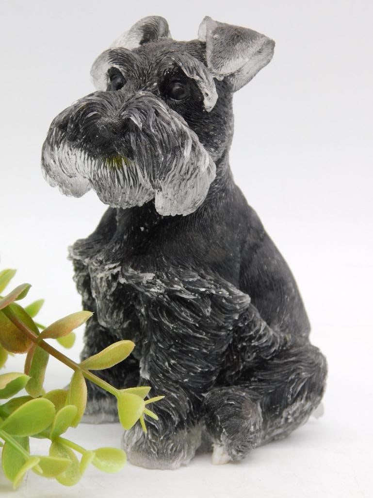 Black and Gray Schnauzer Figurine with Textured Finish: Black and gray schnauzer figurine with detailed textured finish. | Made of a sturdy resin material. | Features a realistic sitting pose. | Base includes small smooth stones embedded in clear resin. | 