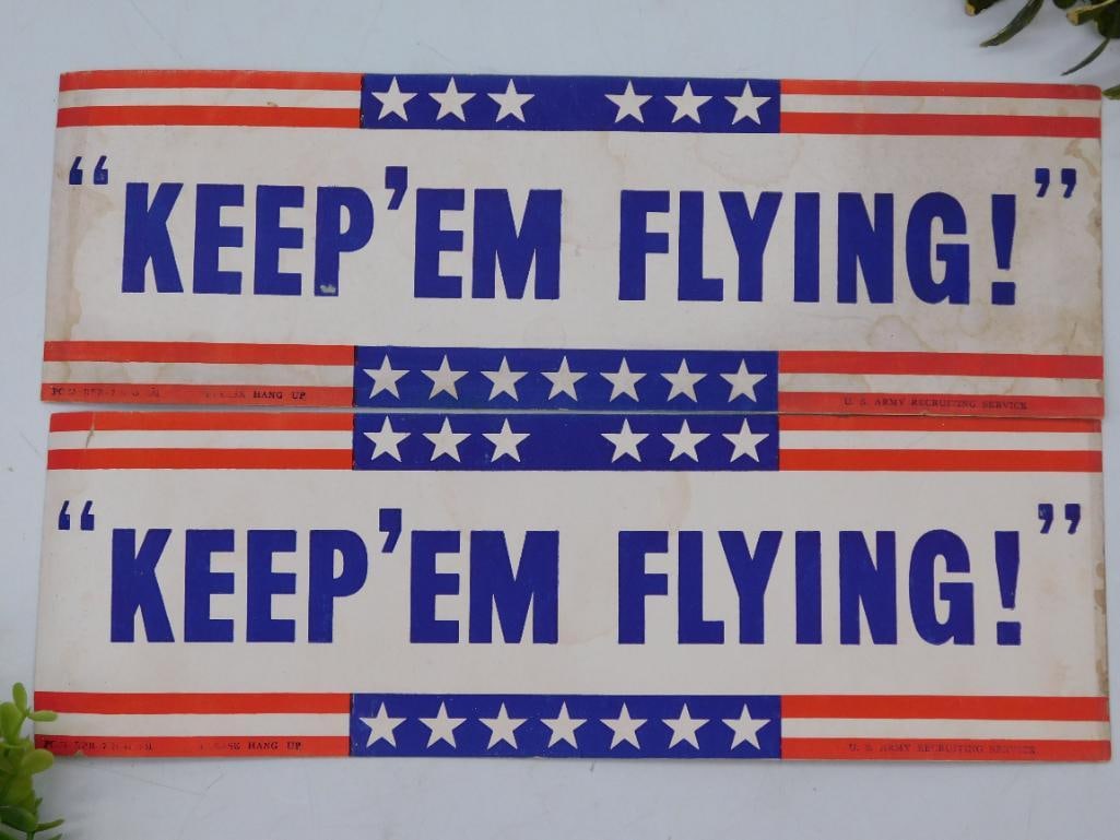 Vintage WWII Era Keep Em Flying Poster Panels: Set of two vintage poster panels featuring the phrase 'Keep 'Em Flying!'. | Includes patriotic red, white, and blue color scheme with star patterns. | Likely dates to the World War II era, promoting m