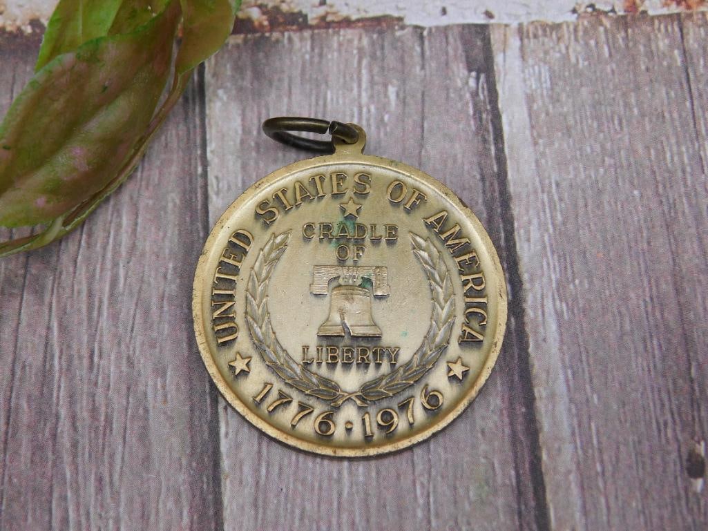 1776-1976 Bicentennial Commemorative Medal with Liberty Bell: This is a 1776-1976 Bicentennial commemorative medal featuring the Liberty Bell and a design depicting the signing of the Declaration of Independence. The medal is made of metal and includes a loop fo