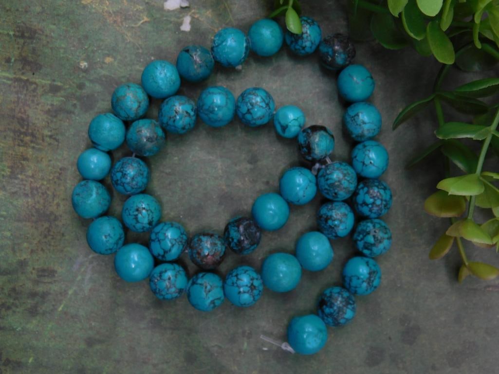 Strand of Blue Turquoise Beads with Veining Pattern ROCK STONE LAPIDARY SPECIMEN: Strand of round blue turquoise beads, each featuring a distinctive veined pattern. | Total weight of the strand is 56 grams, as labeled. | Beads appear uniformly sized, suitable for jewelry or craftin