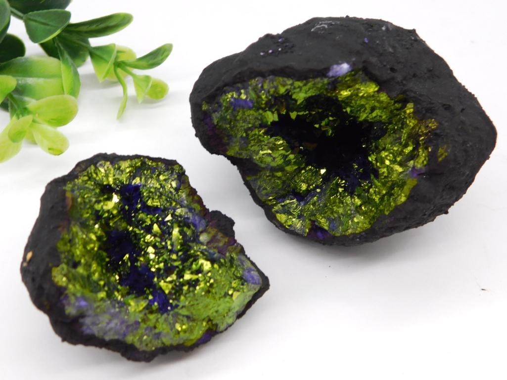 Geode Rock Stone Lapidary Specimen: - Natural geode specimen featuring vibrant green and purple colors within. | - Divided into two halves for display, showcasing a textured, dark outer surface and colorful interior. | - Measurements: w