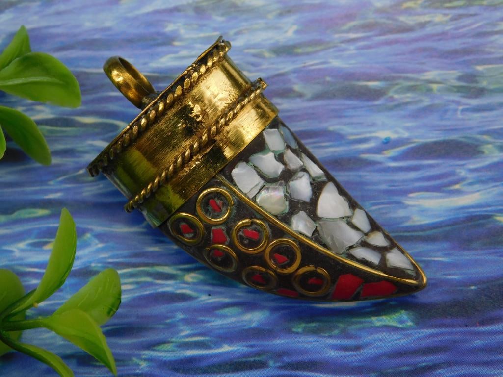 Red Coral and Abalone Mosaic Horn Pendant With Mixed Patterns: - Crafted in goldtone metal with detailed accents along the edges. | - Features a mosaic inlay design with red, black, and white patterns. | - Shaped as a horn, providing a unique and stylish appearan