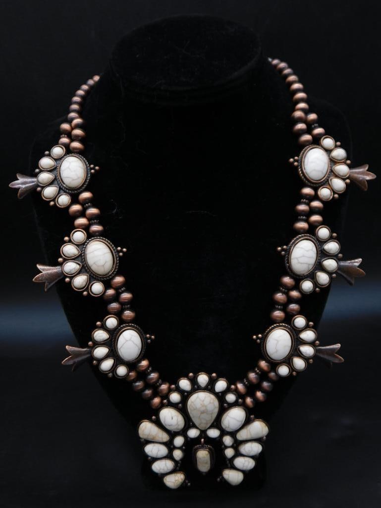 Fashion Squash Blossom Stone Beaded Necklace with Metal Accents: - Features white, stone-like cabochons set in decorative metal bezels. | - Accented with metal beads and uniquely shaped station pieces. | - Includes a prominent central pendant arrangement. | - Appea