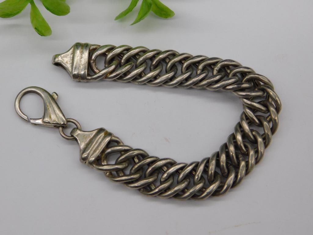 Sterling Silver Bracelet, 23 Grams, Made in Italy: - Material: .925 sterling silver with visible markings for authenticity. | - Weight: Approximately 23 grams. | - Style: Woven chain design with a secure lobster clasp closure. | - Origin: Stamped as m