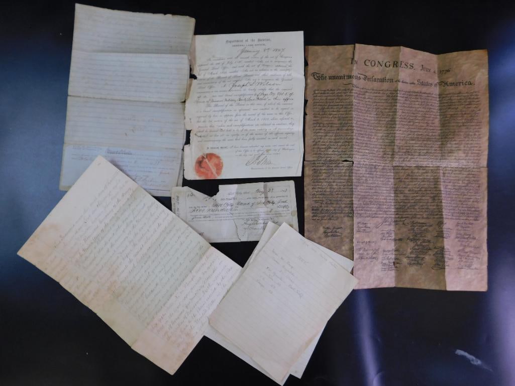 Historical Documents Including Declaration Copy: Includes several historical documents, such as handwritten papers and printed materials. | - One item appears to be a reproduction or facsimile of the Declaration of Independence, dated July 4, 1776, 