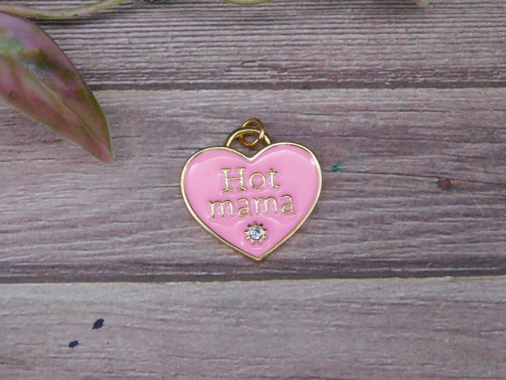 Gold-Tone Pink Heart Charm with ?Hot Mama? Lettering: Gold-tone heart-shaped charm with pink enamel featuring 'Hot Mama' lettering in raised gold-tone text. Adorned with a small clear stone at the bottom. Lightweight and small-sized, as shown rel