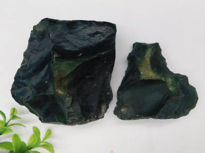 Bloodstone Rock Stone Lapidary Specimen: This lot includes two rough rocks characterized by green and black hues. Each piece has a natural and jagged texture. The approximate combined weight appears to be 6 grams, as indicated. A ruler for s