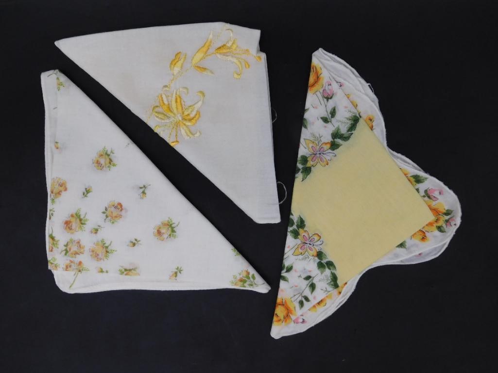 Set of Three Floral Handkerchiefs: This lot features three handkerchiefs with floral designs. Patterns include yellow flowers with embroidery, pink flowers, and a design incorporating yellow and green tones. Made of lightweight materia
