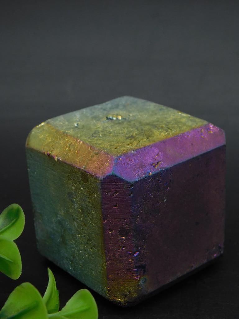 Rainbow Titanium Cube Rock Stone Lapidary Specimen: This listing features a hexagonal bismuth crystal with a striking iridescent finish. The crystal showcases vibrant colors ranging from purple to gold. It is labeled as Lot 704926, weighing 205 grams,