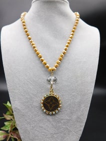 Gold Beaded Necklace with Decorative Pendant