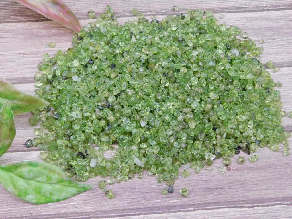 Loose Peridot Gemstones ? 100 Grams: This listing features 100 grams of loose peridot gemstones. The stones are small and suitable for various purposes, including crafting, jewelry-making, or collection. They feature their natural green