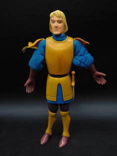 Action Figure with Yellow Armor and Blue Outfit: Action figure featuring yellow armor over a blue outfit. Includes molded details and movable joints. Blonde hair complements the bright armor. Item shown with ruler for scale. Appears in good conditio
