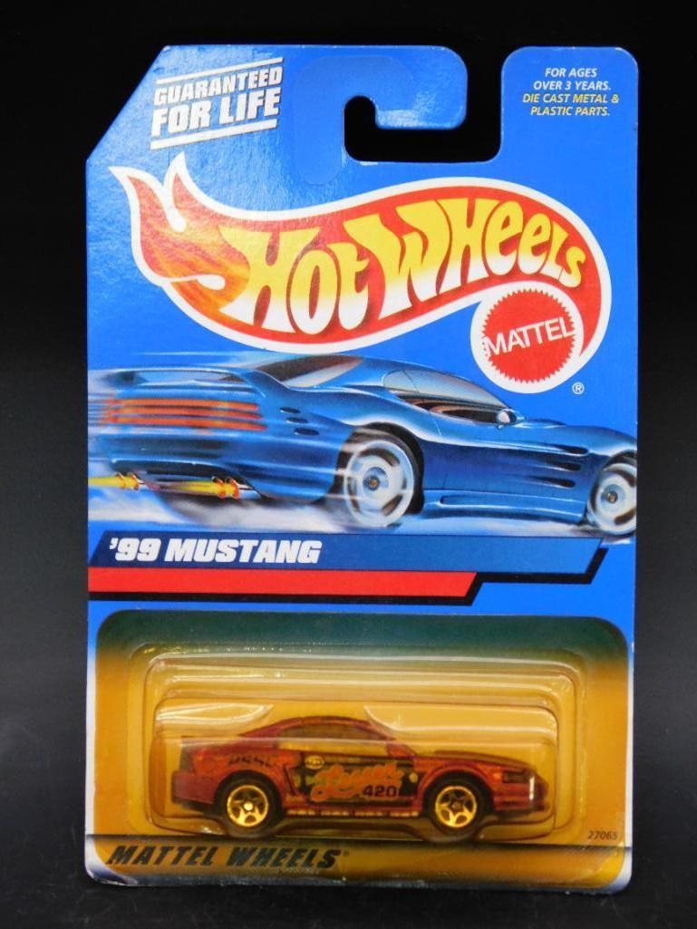 Hot Wheels 1999 Mustang Carded Model: Hot Wheels collectible featuring the '99 Mustang in its original carded packaging. The item remains unopened with minor wear visible on the card from storage. Made by Mattel, includes colorful graphic