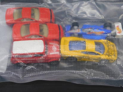 Lot of Assorted Hot Wheels Cars by Mattel: This lot contains multiple Hot Wheels vehicles manufactured by Mattel. Included are several cars, including a red 1967 Austin Mini Van (noted as trademarked in 2014) and others such as a Formula 1-sty