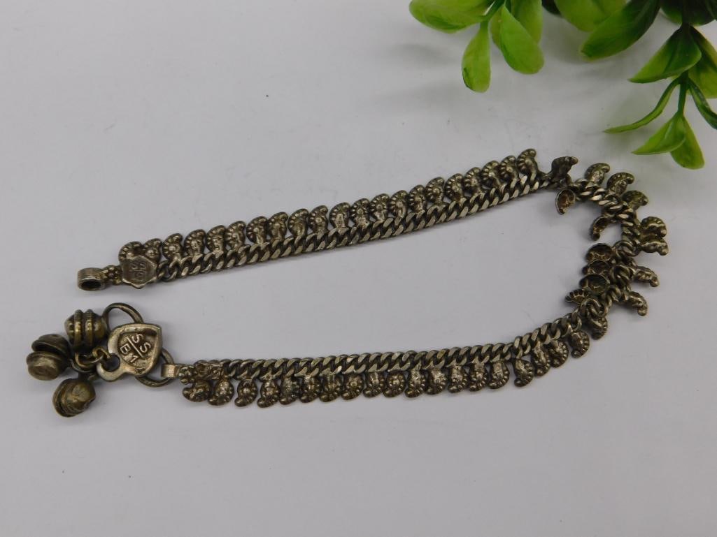 Sterling Silver Bracelet with Heart Clasp and Bell Charms: - Sterling silver bracelet with intricate design details, marked "SS B1." | - Features a heart-shaped clasp adorned with small articulated bell charms. | - Weight noted as 17 grams. | - Includes decor