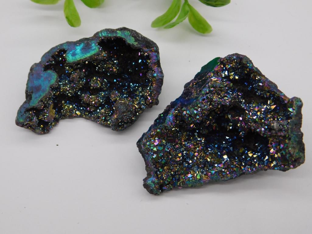 Alien Egg Geodes Rock Stone Lapidary Specimen: - Two quartz geodes with a stunning iridescent finish. | - Combined weight of 35 grams, as labeled. | - Each geode has vibrant colors with natural crystal formations. | - Display piece is accompanied